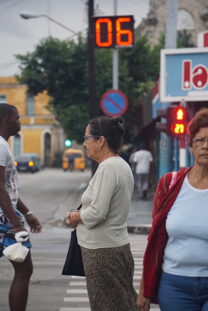 People in Havana walking through a crosswalk.